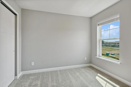 There are two perfectly sized secondary bedrooms with spacious closets. (Photo of a completed home, actual home's finishes may vary slightly)