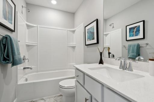 The spacious upper level bath provides plenty of space for everyone to get ready in the morning. (Photo of decorated model, actual home's finishes may vary slightly)