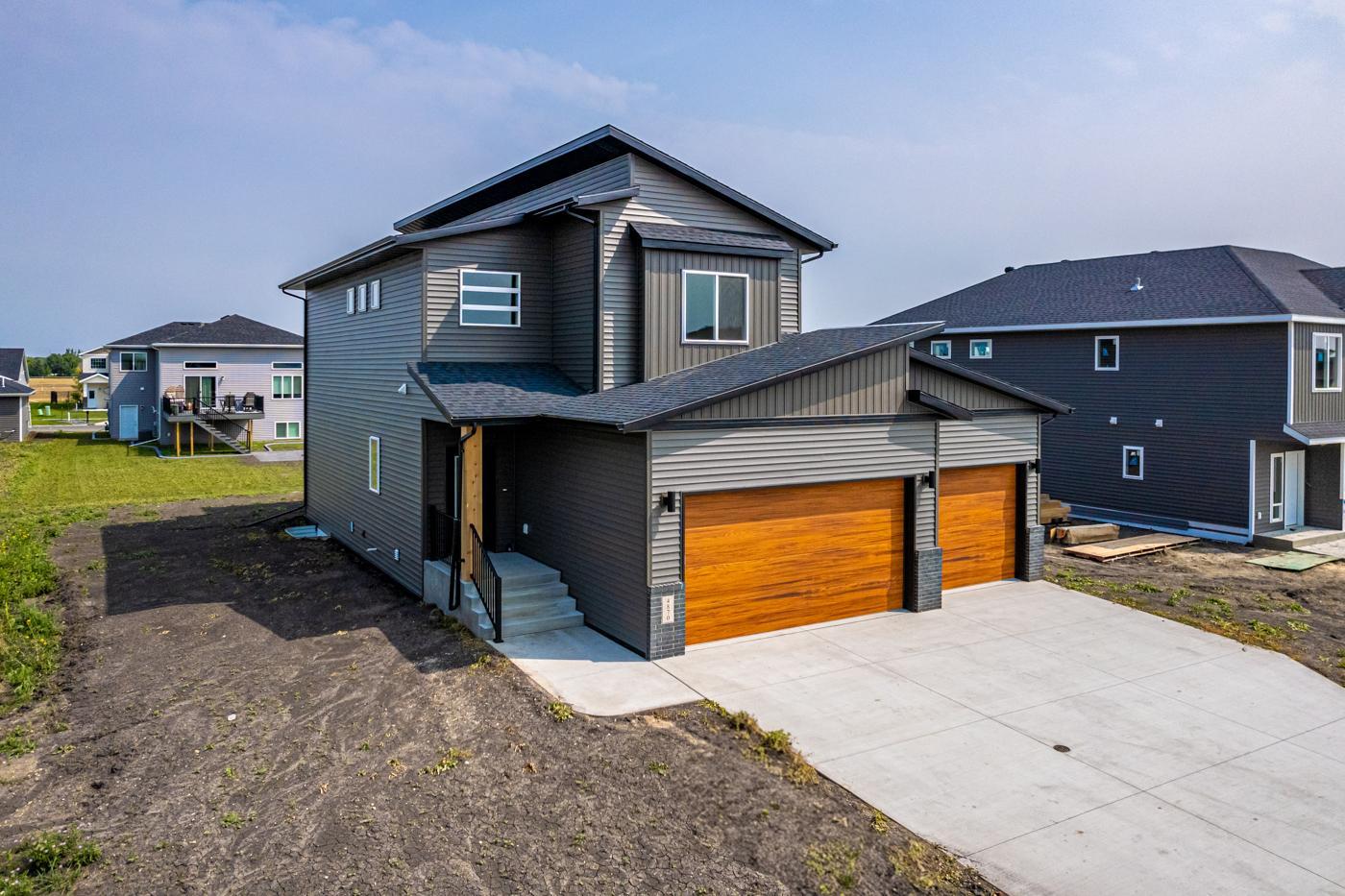 Exterior - Modern roofline w/ shed roof & Cedar woodgrain garage doors!