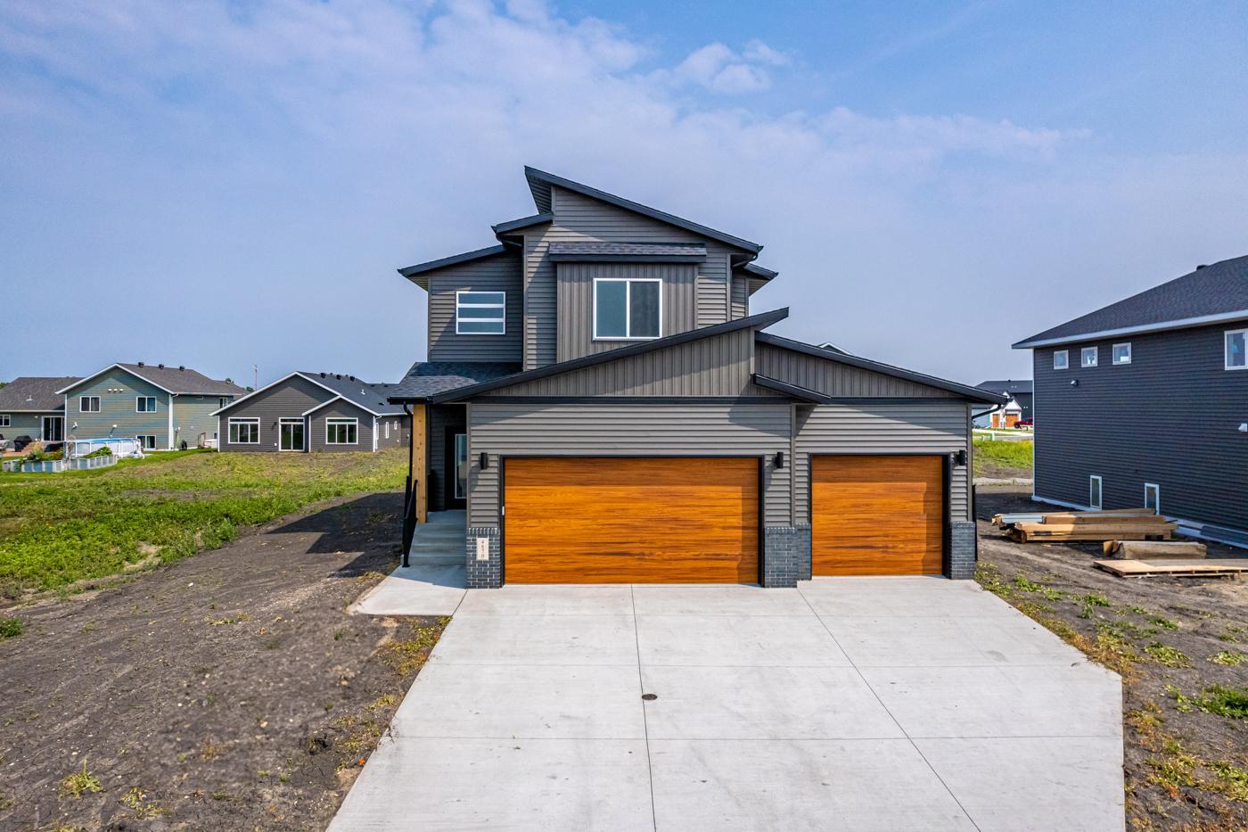 Exterior - Modern roofline w/ shed roof & Cedar woodgrain garage doors!