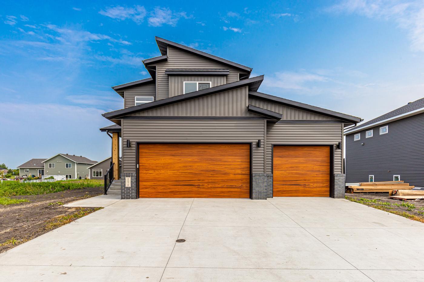 Exterior - Modern roofline w/ shed roof & Cedar woodgrain garage doors!