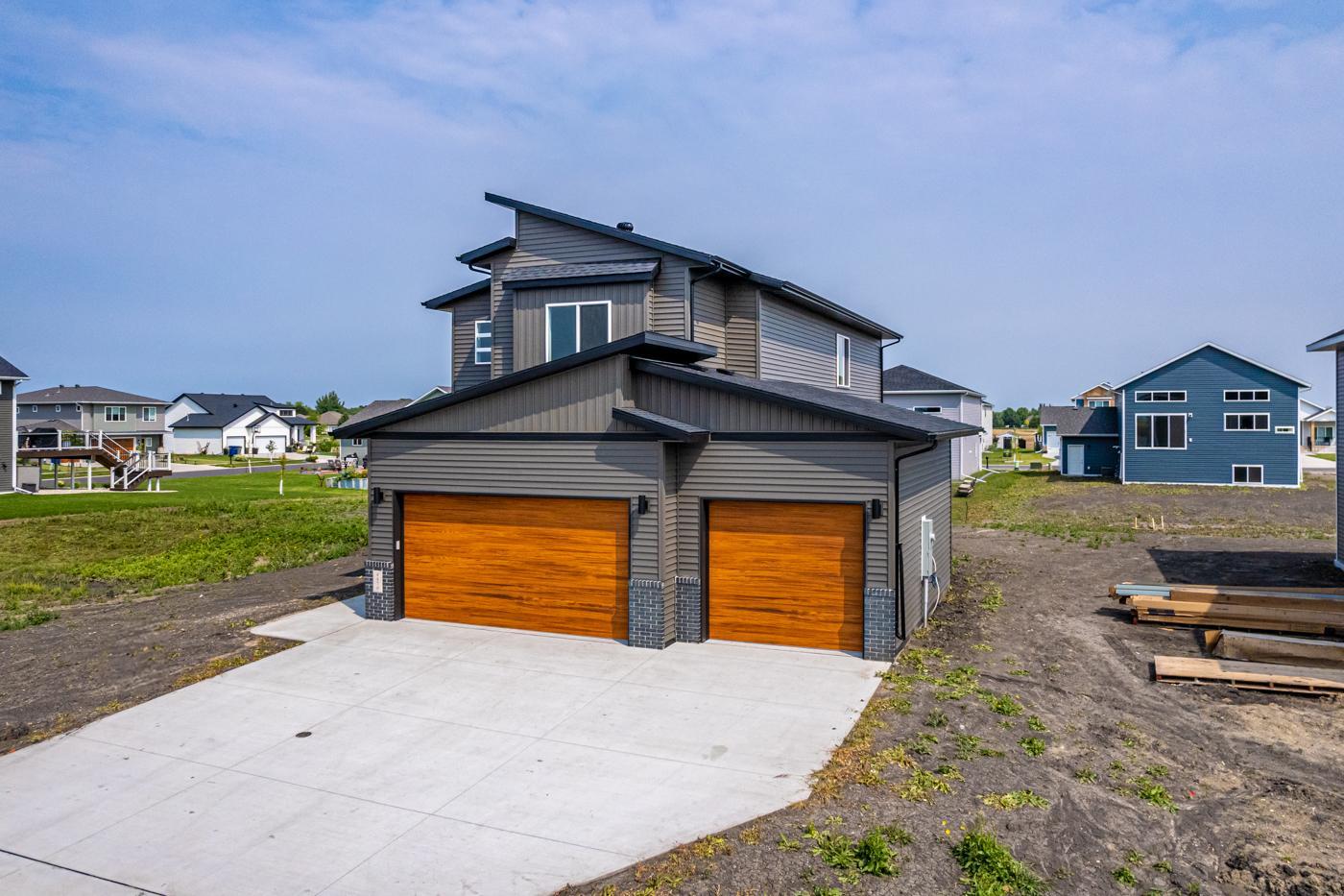 Exterior - Modern roofline w/ shed roof & Cedar woodgrain garage doors!