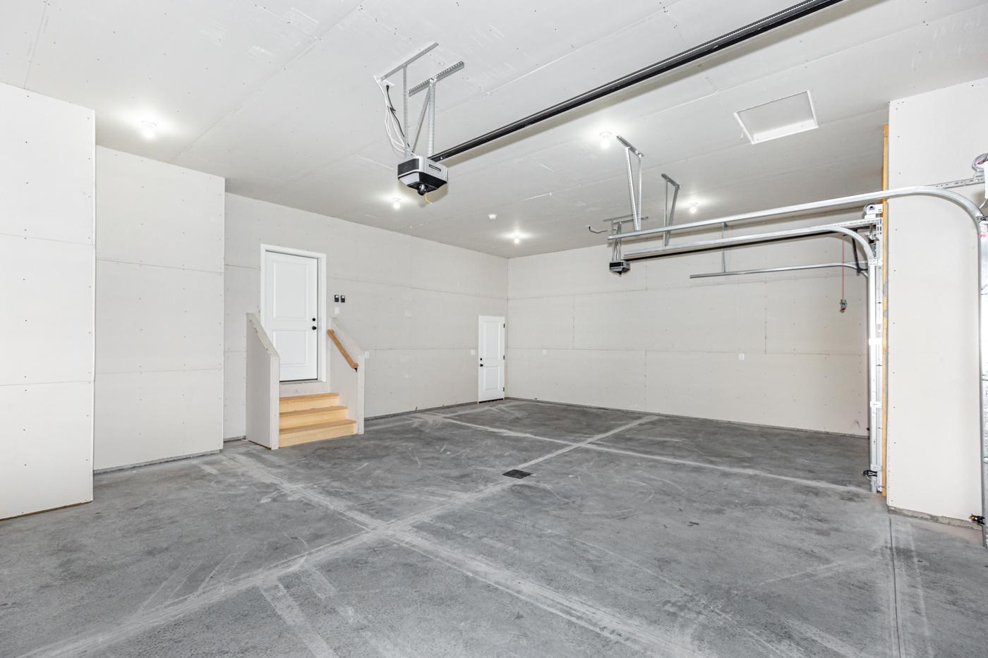 Garage - Insulated, sheetrocked, 2 wifi openers, upgraded lighting, utility door, and floor drain!