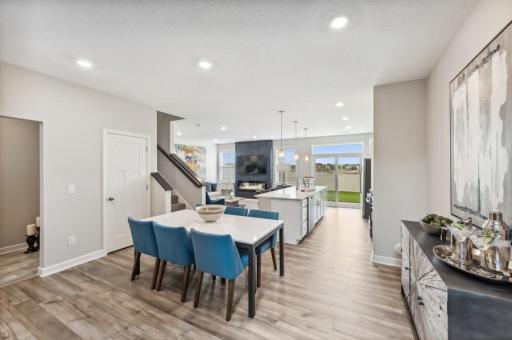 Soaked in natural sunlight, the homes dining room has ample room for a dining table located in the heart of the home. (Photo of decorated model, actual home's finishes may vary slightly)