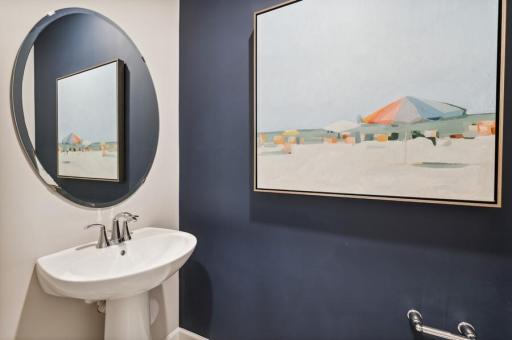 Powder room off main level. (Photo of decorated model, actual home's finishes may vary slightly)