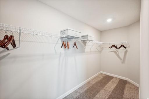 The owner's suite features an incredible walk-in closet. (Photo of decorated model, actual home's finishes may vary slightly)