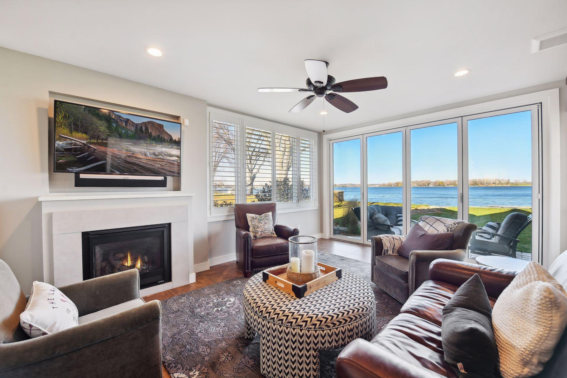 Sunroom with access to outdoors, heated floor and gas fireplace.