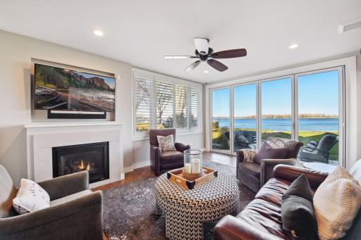 Sunroom with access to outdoors, heated floor and gas fireplace.