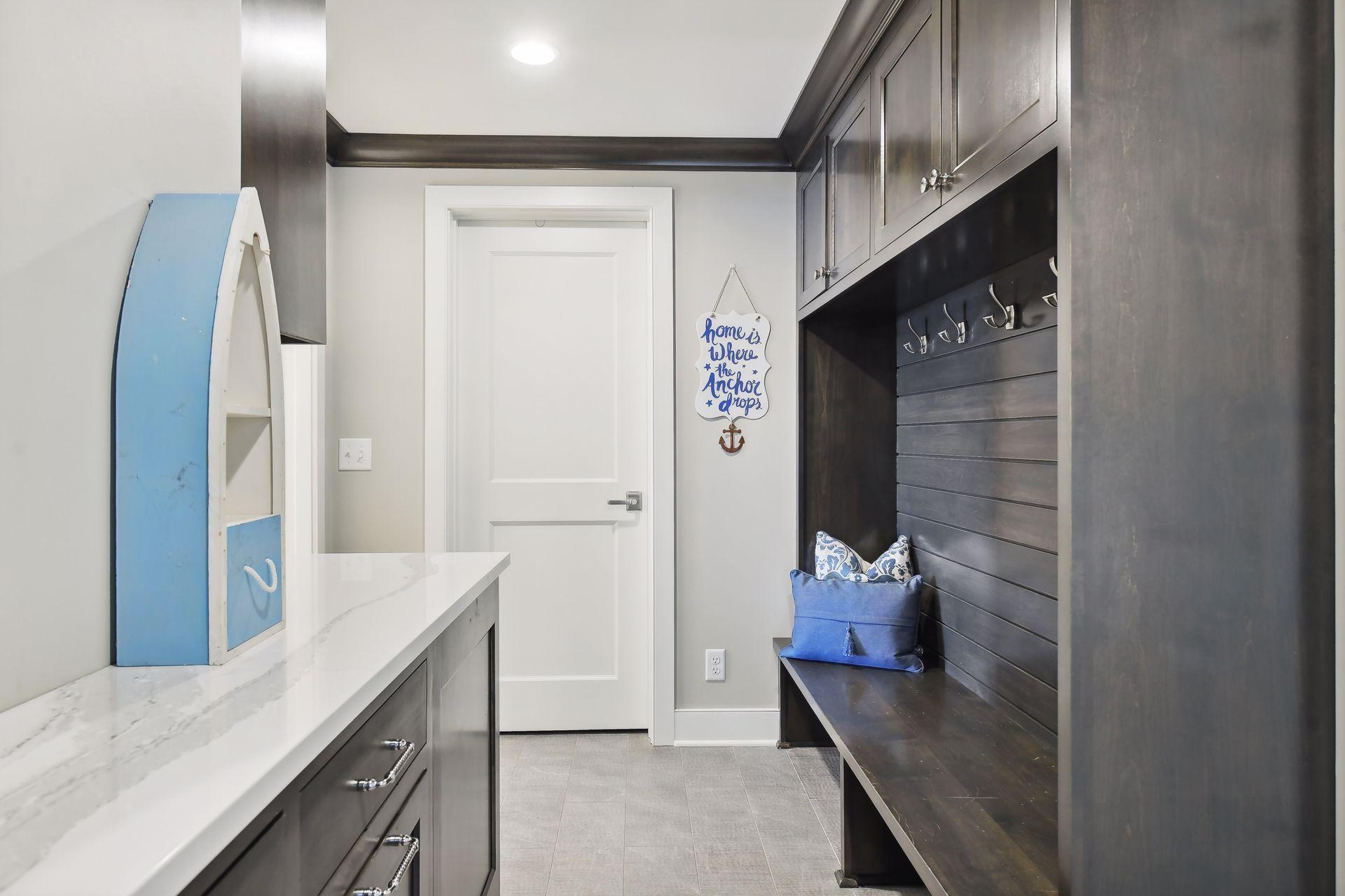 Mudroom with built in bench/hooks and ample storage.