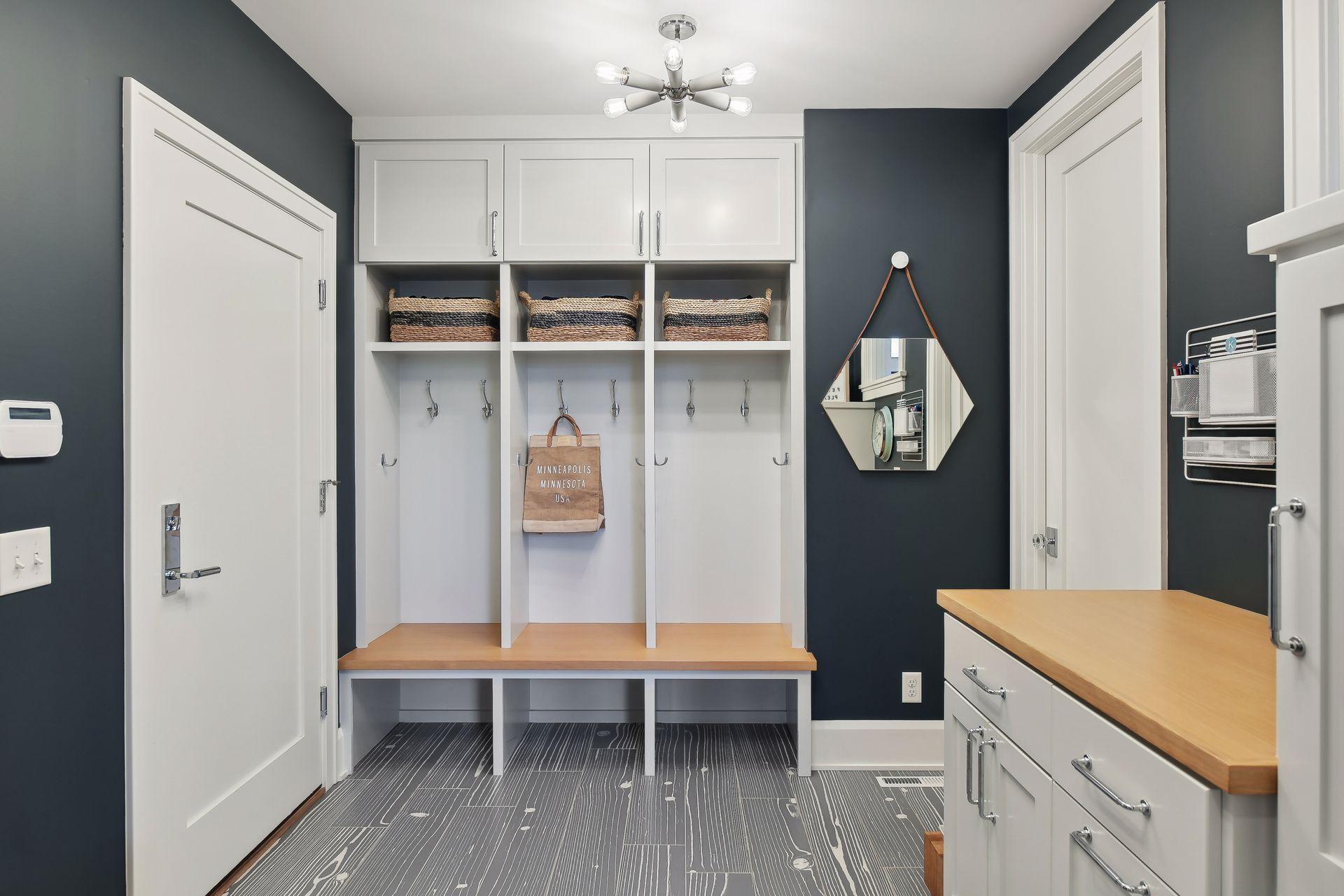 Nicely sized mudroom with convenient cubbies & cabinets + separate coat closet.