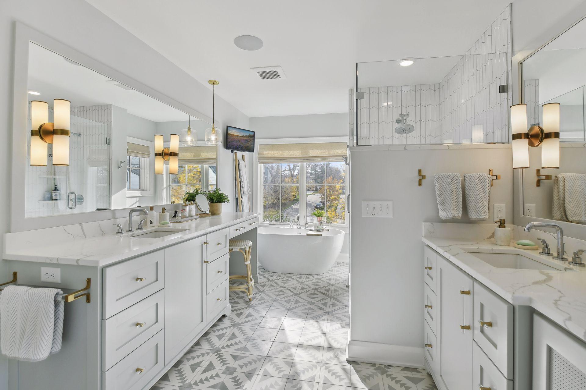 Primary bathroom with a calming palette, heated flooring, separate tub & shower + 2 vanities.