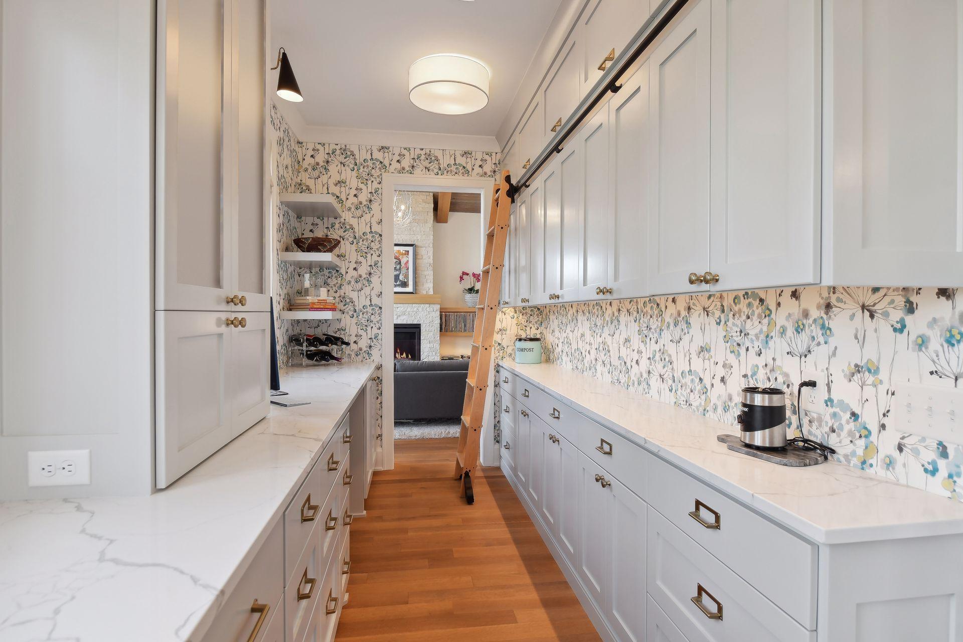 The butler's pantry has a plethora of extra cabinetry with a sliding ladder for the high ones.