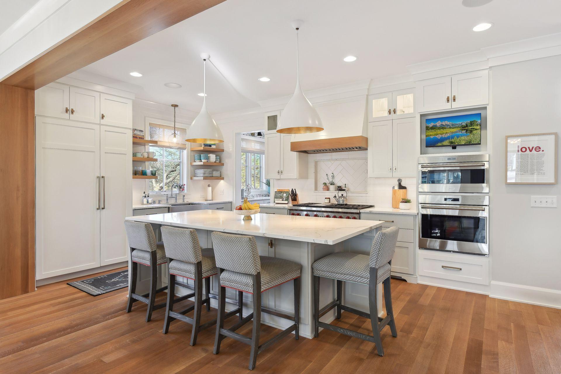 Amazing gourmet kitchen with quartz countertops and Wolf appliances. The long center island seats 4 counter stools and has hidden cabinetry for extra storage.