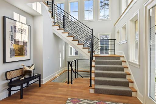 Wide custom-designed floating staircase with amazing bright light.