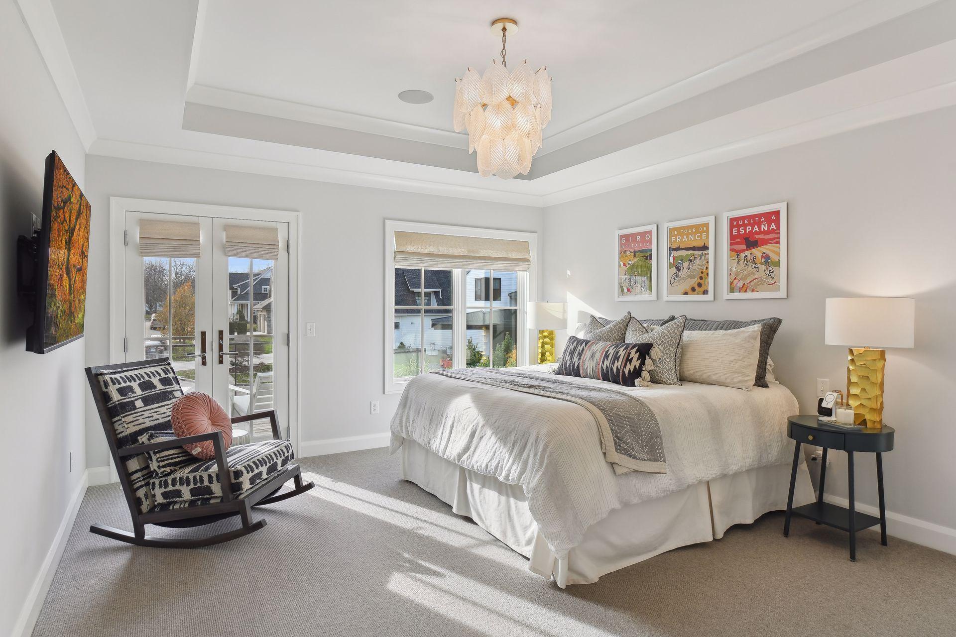 The upper-level Primary suite has raised & coved ceiling detail, wool carpeting, & French doors leading to a sweet balcony overlooking the front cul-de-sac.