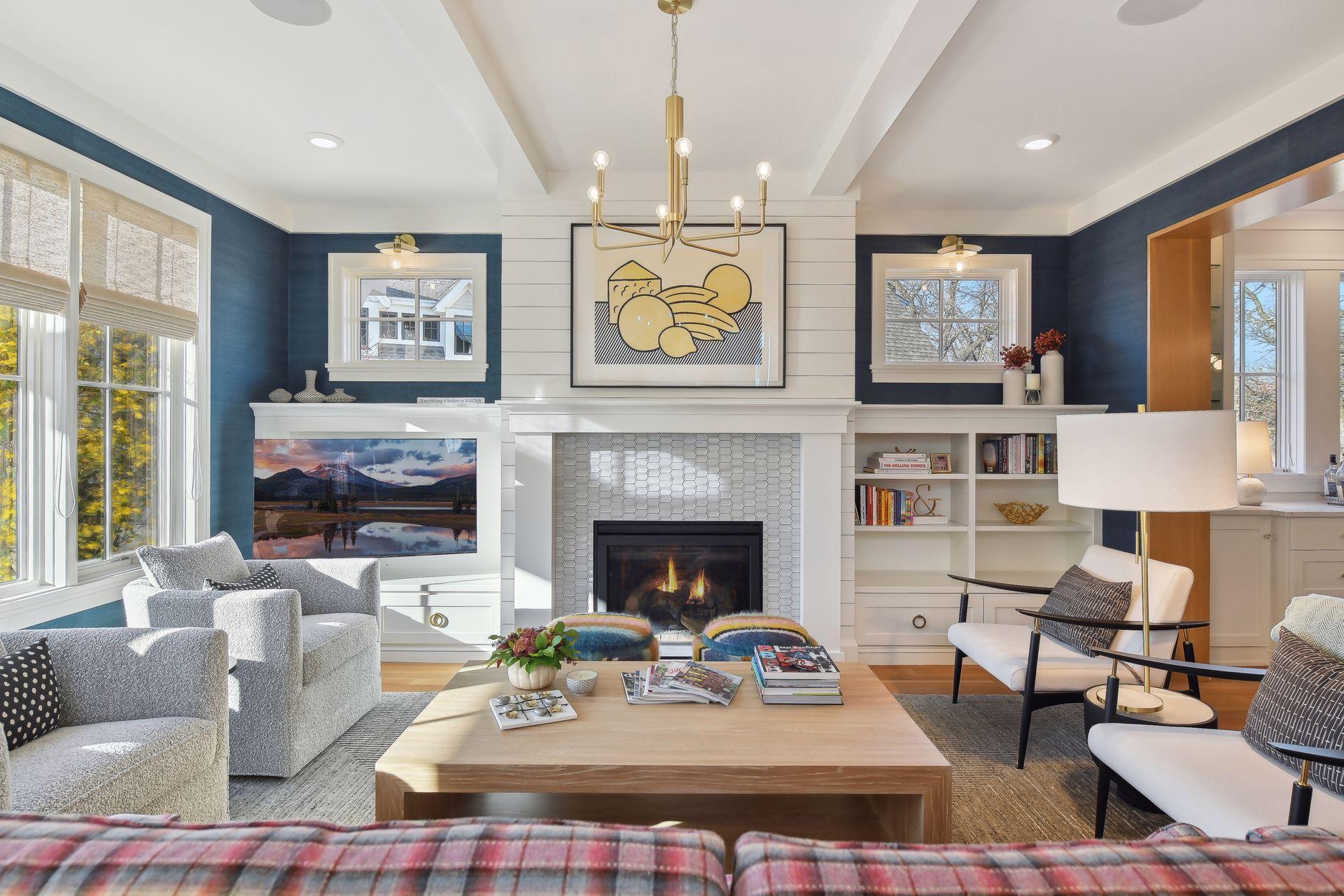 The Sun-filled living room has a remote-controlled gas-burning fireplace with a mantel & ship-lap surround.