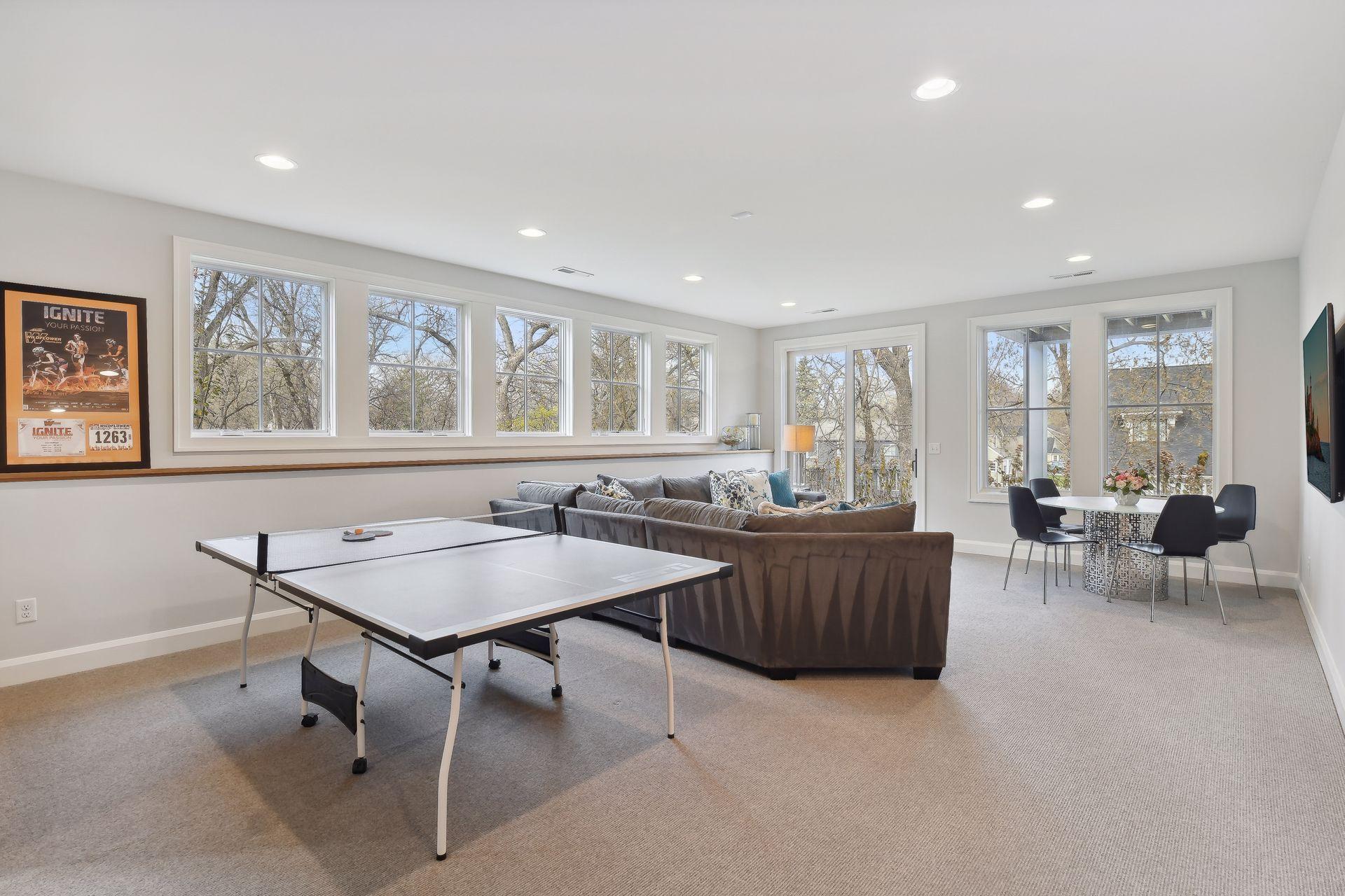 The lower-level amusement room is filled with natural light, and he walks out to the backyard.
