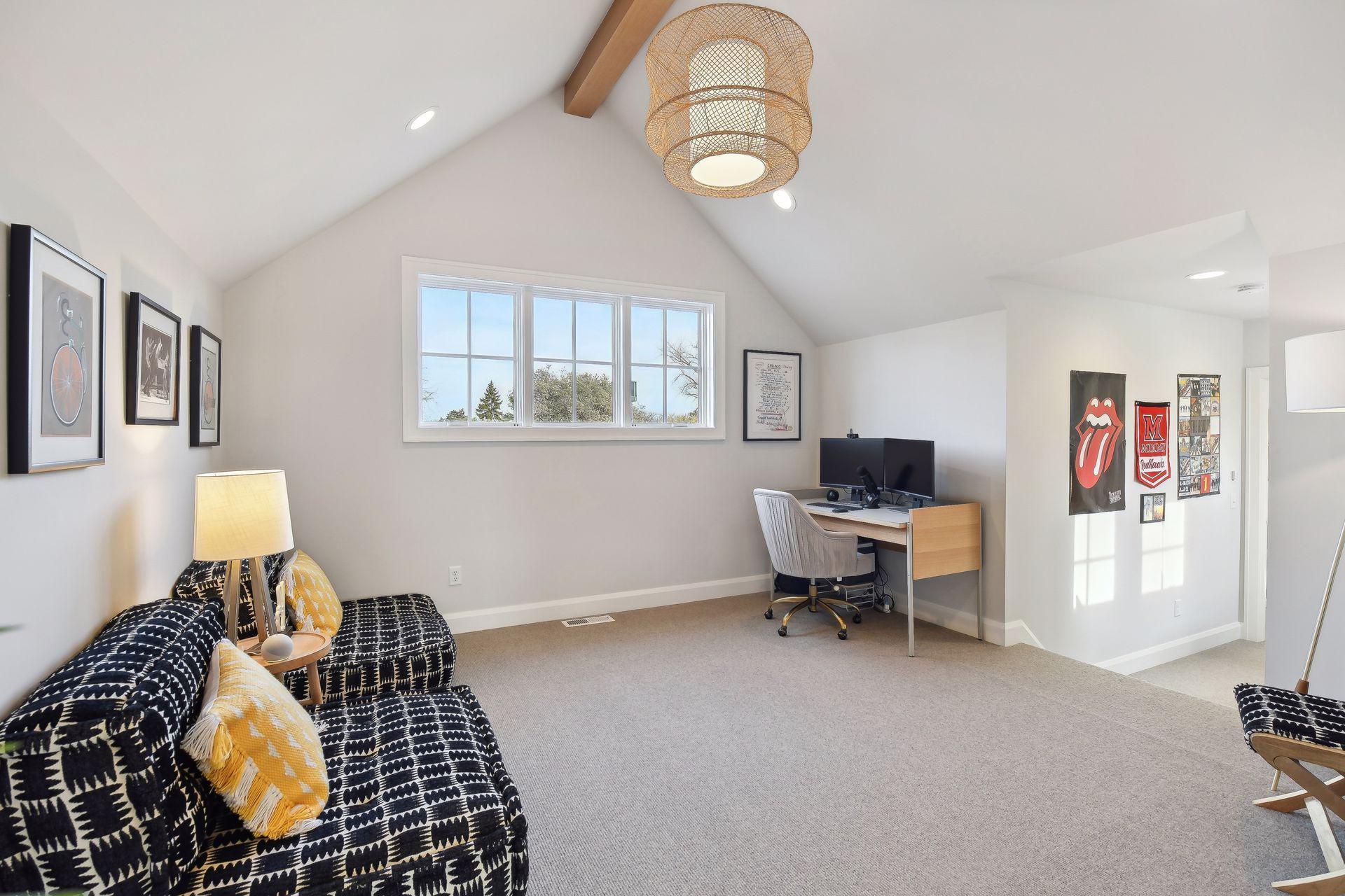 The upper-level bonus room with a vaulted ceiling sits in between the additional bedrooms upstairs. It's definitely the perfect place to lounge, play games or work!