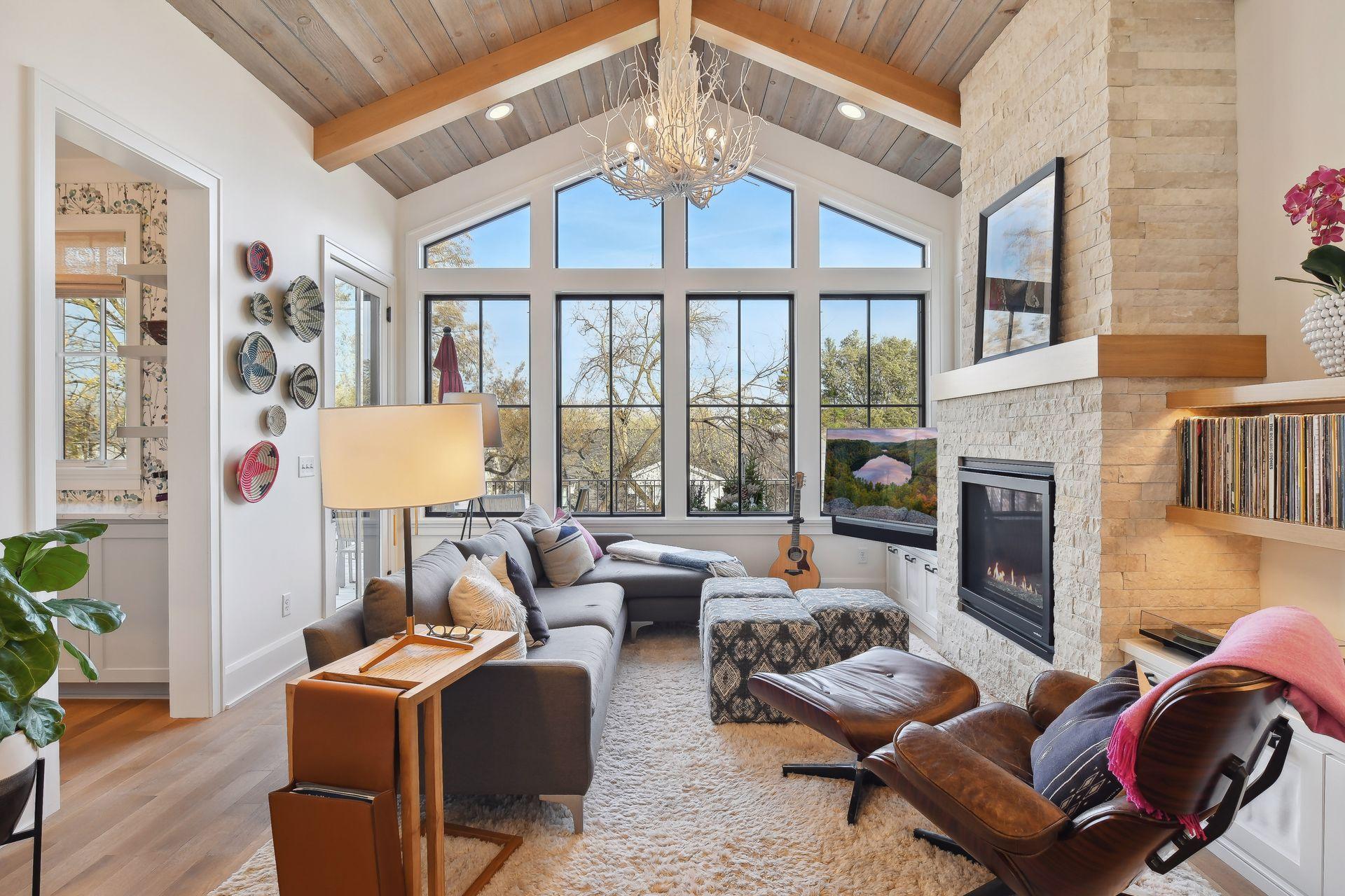 The back den is truly an architectural gem with a vaulted ceiling, big windows, and a modern fireplace. Plus serene views of the deck and trees.