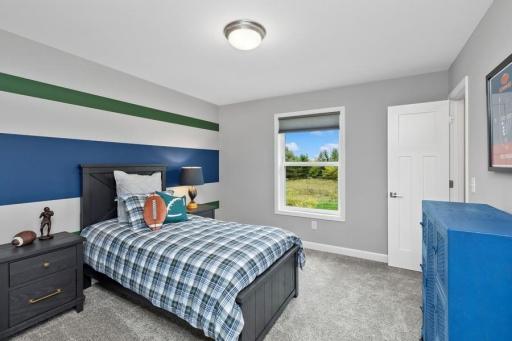 The third generously sized secondary bedroom with a spacious closet. (Photo of decorated model, actual home's finishes may vary slightly)