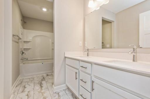 Hall Bathroom featuring a double vanity, this secondary bath is sure to keep everyone moving during those busy mornings!