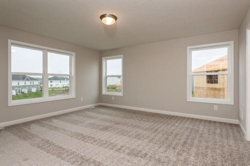 The primary bedroom features an abundance of natural light. Enjoy the exclusivity of a private bath and huge walk-in closet.