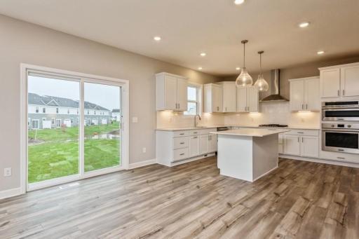 Open kitchen and dining room. Soaked in natural sunlight, the homes eat-in dining room has ample space for a dining table located in the heart of the home.