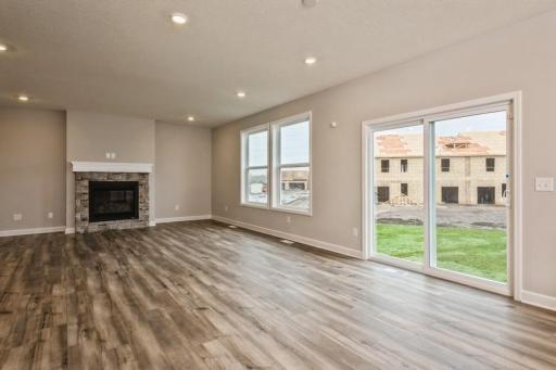 Soaring windows provide an abundance of natural light flow throughout the main level, including this nicely sized great room, featuring a natural gas fireplace.