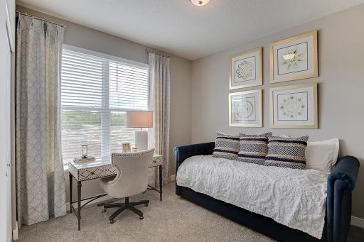 Tucked back off the mudroom, and away from the hustle and bustle of the main level living spaces, this bedroom resides adjacent to a 3/4 bath and serves as the perfect guest room or your home office! Photo of model home, color and options will vary.
