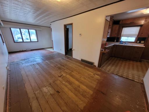 View of dining/living room -door to east bedroom