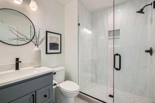 Lower level bathroom. Photos of model at 5655 Buffington.