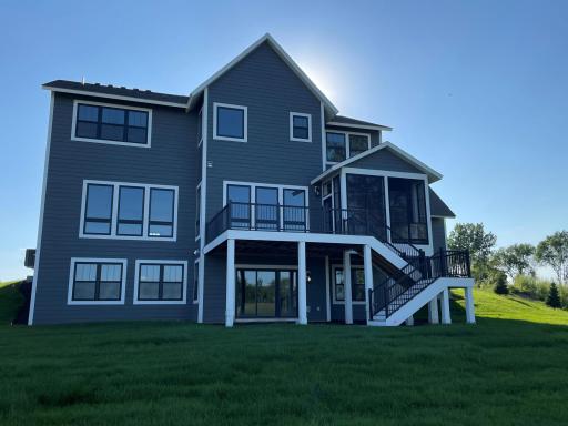 Large backyard for future improvements and striking exterior complete with deck and screened porch with fireplace!