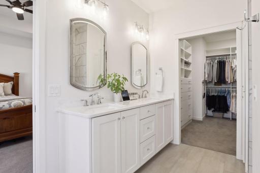 The double vanity is an exceptional space with custom cabinetry and gorgeous lighting and hardware selections.