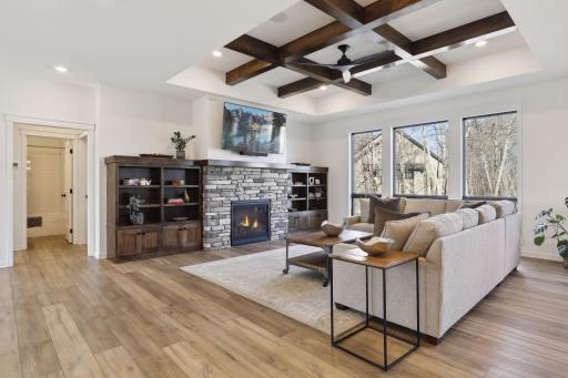 Gorgeous Custom Built-ins and a stone fireplace with gorgeous upgraded selections will impress.