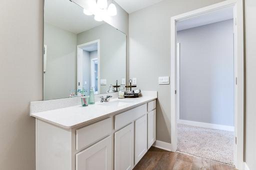 Each of those three upper level secondary bedrooms have access to this full bath, which is also features this huge, Quartz coated vanity! (Photo of model, colors may vary)