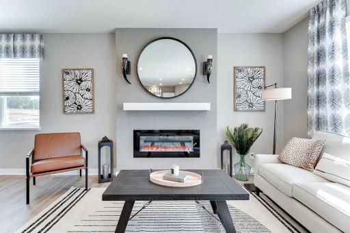 One of many highlights in the main level, the homes fireplace offers a touch of modernization of a space already loaded with a contemporary layout! (Photo of model, colors may vary)