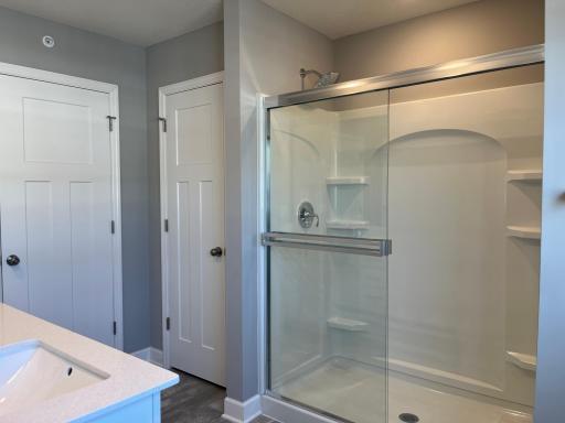 An extension of the owner's suite, this private and spacious bathroom contains a double-vanity, a shower, water closet and a linen closet!