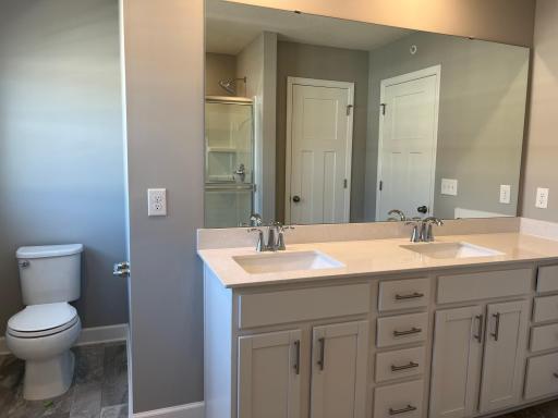 Relax in your private oasis featuring a double-vanity, shower, water closet and linen closet.