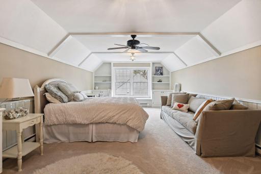 A few steps down from the upstairs hallway you'll find this very spacious bonus room with built-ins, cupboard space and auxiliary heat.