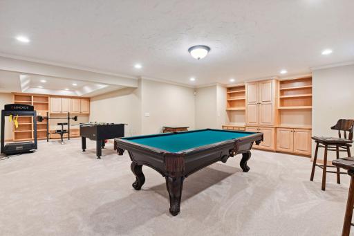 Lower level amusement room with plenty of space for pool and other gaming activities