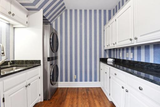 Convenient, newly remodeled main level laundry room includes access to the back yard and patio. Perfect mud-room buffer.