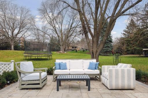 A gently rolling, expanse of yard features a new patio, new landscaping and a new decorative metal fence. You'll love the sense of security and privacy.