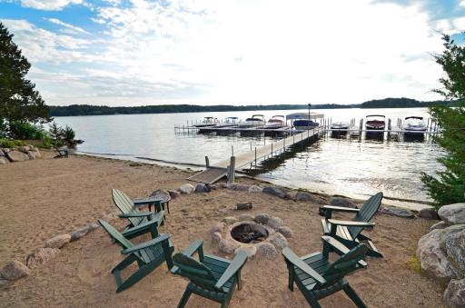 The sandy neighborhood beach features access for swimming, and a cozy firepit for cool summer evenings.