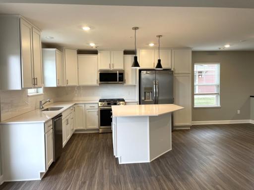 Enjoy plenty of seating at the kitchen island and dining area adjacent to the kitchen. Perfect for entertaining or having a family meal together.