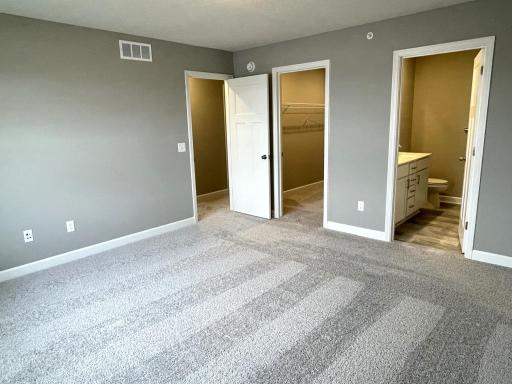 Another view of the spacious owner's suite with a view of the private bath.