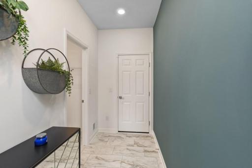 This spectacular mudroom provides enough space for benches, lockers and cubbies. Plus enjoy the spacious entry closet and powder bath. (Photo of decorated model, actual home's finishes may vary slightly)