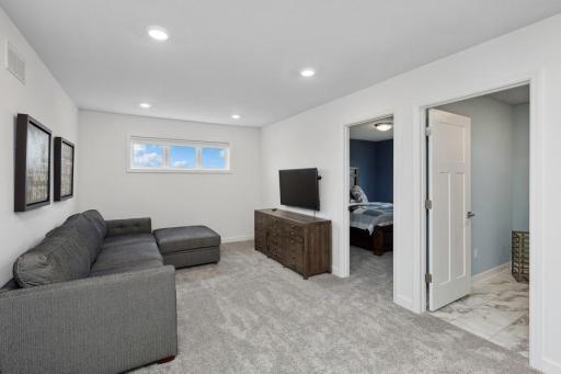 Located on the upper level, this perfectly sized living space has enough room for a desk, television and seating for all. (Photo of decorated model, actual home's finishes may vary slightly)