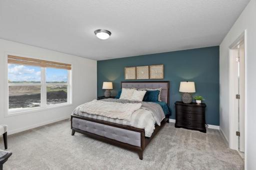 Find your retreat in this stunning owner's suite. Enjoy the exclusivity of a private bath and huge walk-in closet. (Photo of decorated model, actual home's finishes may vary slightly)
