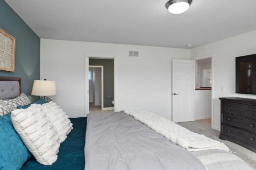 This private owner's suite boasts an abundance of space for a king-sized bed and many other furniture arrangements. (Photo of decorated model, actual home's finishes may vary slightly)