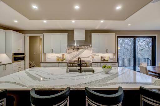Custom cabinets with built-in lighting including convenient pull outs for knife block, utensil and stand mixer